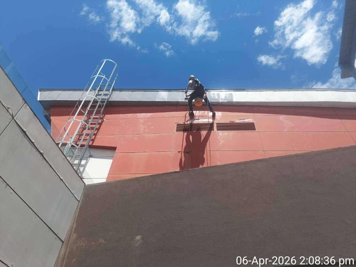 Specialist carrying out high-access facade coating
