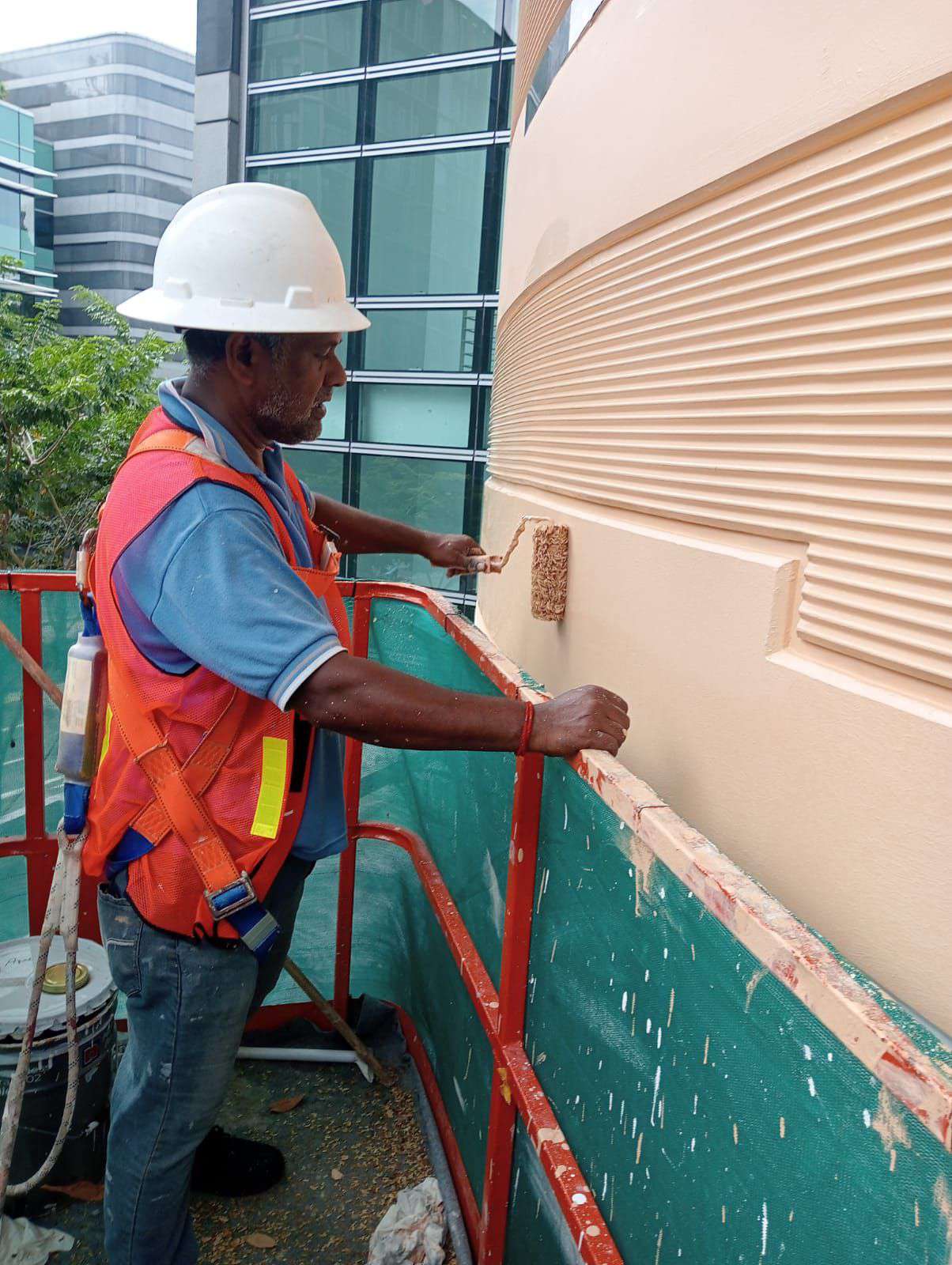 Painter completing detailed exterior wall painting